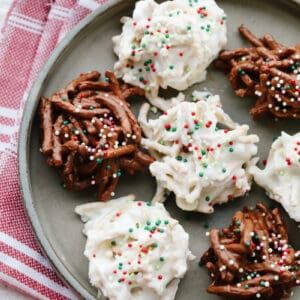 chocolate pretzels with whipped cream and sprinkles on a plate