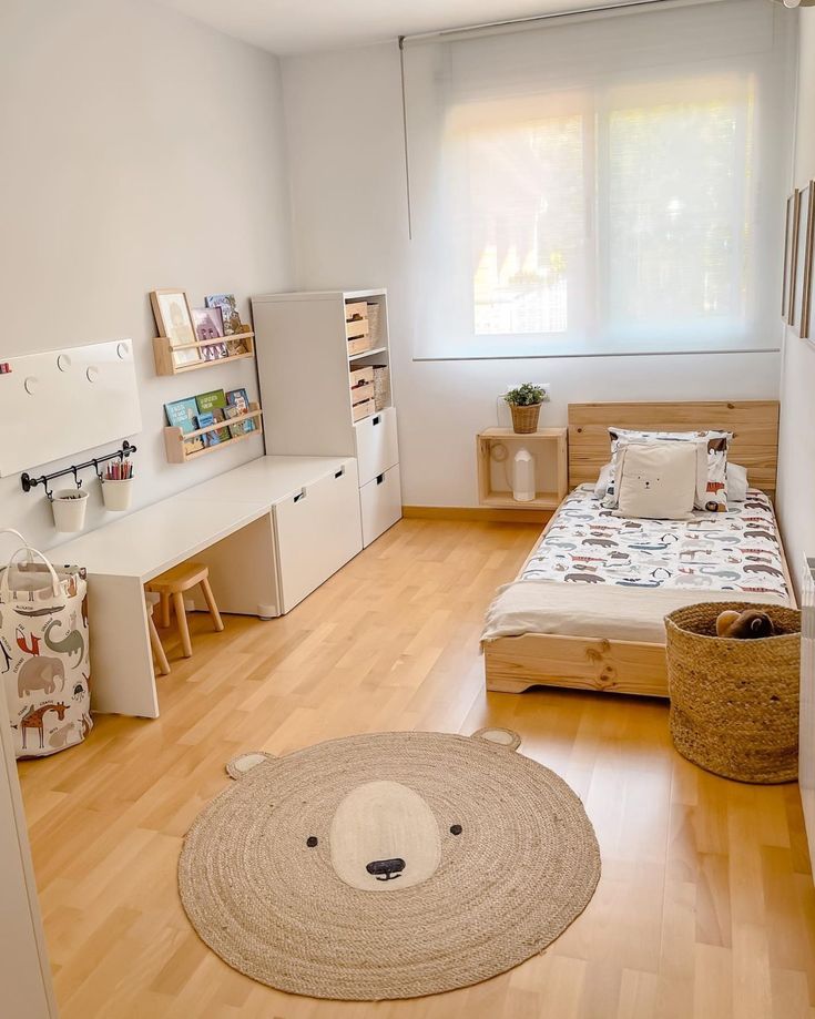 a bedroom with white walls and wooden flooring has a teddy bear rug on the floor