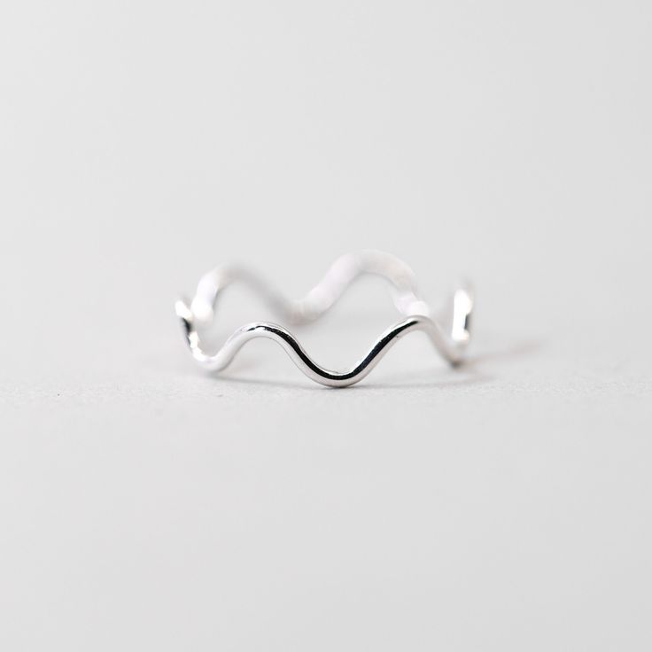 This dainty silver wiggle ring is a fun ring to add to your daily lineup. This ring can be worn on it's own, or combined with our other rings to create a stacked look. Made from .925 sterling silver, it is sure to be a piece that lasts. Each piece is custom-made for you, so please allow 1-5 days for the jewelry to ship. - .925 Sterling Silver - 1.1mm band - Handmade to order - Comes neatly packaged in a kraft jewelry box ready for gifting Minimalist Nickel-free White Gold Midi Rings, Minimalist White Gold Midi Rings Nickel Free, Minimalist White Gold Nickel-free Midi Rings, Gift Wavy Stackable Rings, Trendy Nickel-free Sterling Silver Rings, Minimalist Stackable Wavy Rings, Gift Stackable Wavy Rings, Trendy Sterling Silver Stackable Rings For Everyday, Trendy Everyday Sterling Silver Stackable Rings