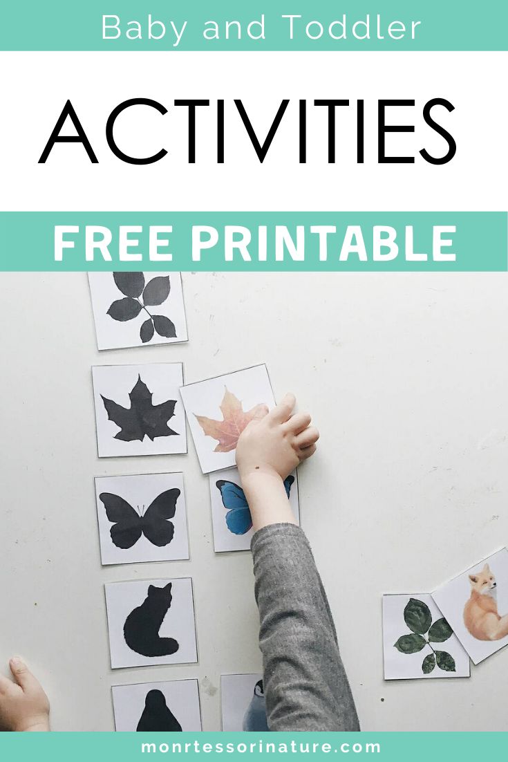 a baby and toddler playing with free printables to help them learn how to make their own animal silhouettes