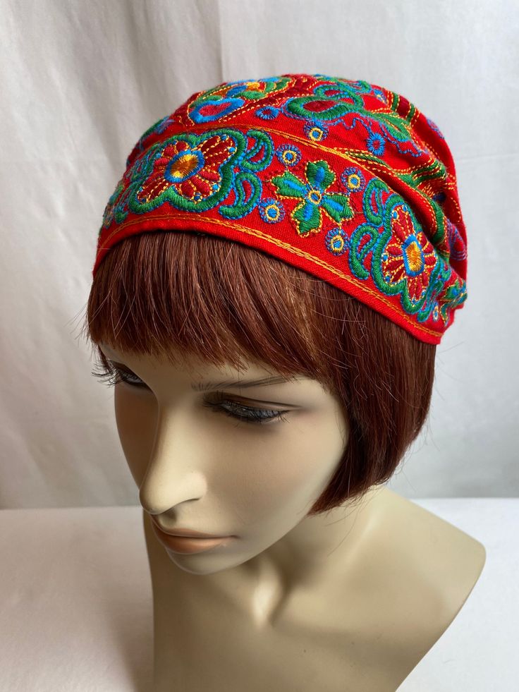 "Charming cotton embroidered cap. It has a timeless old world feel. The colors are bright & bold. I'm not sure of its era, it has no labels or indicators of when it was made. Possibly hand made by someone?  I will say, it has a timeless style.  It has a little covered elastic band in the back which keeps it snug on your head. My feeling it will fit best on a small to average size head.  It is not lined inside. It has a home made quality. No flaws noted.  This is hard to measure honestly, but I w Adjustable Handmade Cotton Bandana, Handmade Adjustable Cotton Bandana, Cotton Bandana For Festivals, Bohemian Beanie Headwrap, One Size Cotton Bandana For Festival, One Size Fits Most Cotton Bandana For Festival, Traditional Headscarf As Headband, One Size Cotton Bonnet, Embroidered Cotton Beanie