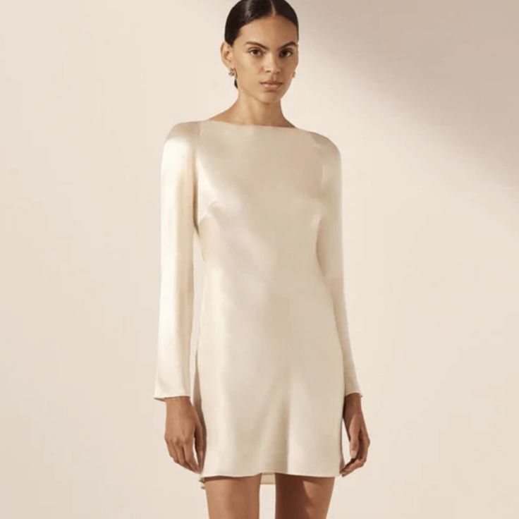 Shona Jo Long Sleeve Backless Mini Dress In Cream In A Lenzing Ecovero With Luxurious Satin Finish. Nwt From Bridal Collection Silk Touch Fabric Luxurious Sheen Round Neckline With Tie Closure Long Slim Sleeves Low Open Back With Cowl Detail Mini Length, Cut On The Bias Medium Weight, Non-Stretchy Woven 58% Lenzing Ecovero 42% Viscose Lined Designed In Australia Available Online At Full Price Winter Wedding Rehearsal Outfit, Long Sleeve Dinner Dress, Short White Dress With Sleeves, Fall Rehearsal Dinner Dress For Bride, Fall Bridal Shower Dress, Dresses For Engagement Photos, Fall Elopement Dress, Short White Boho Dress, Cream Dresses