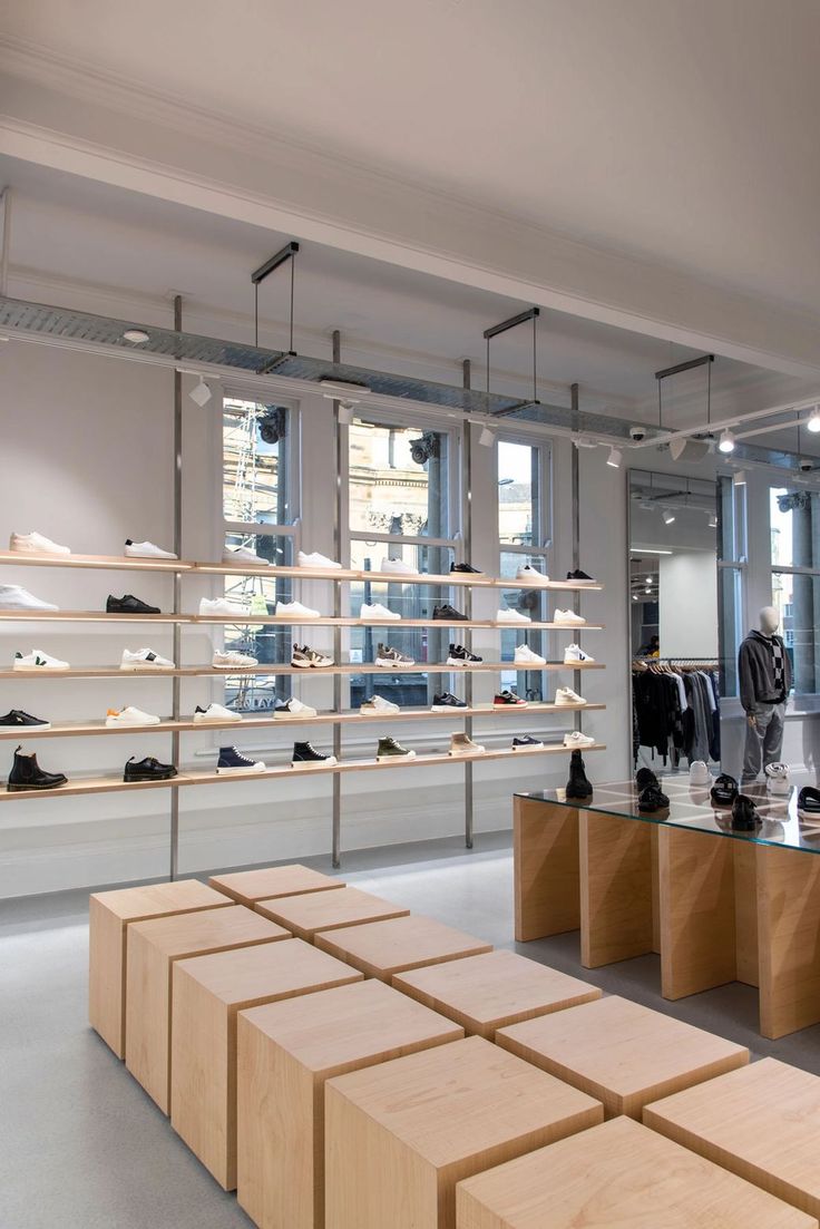 the inside of a shoe store with wooden shelves