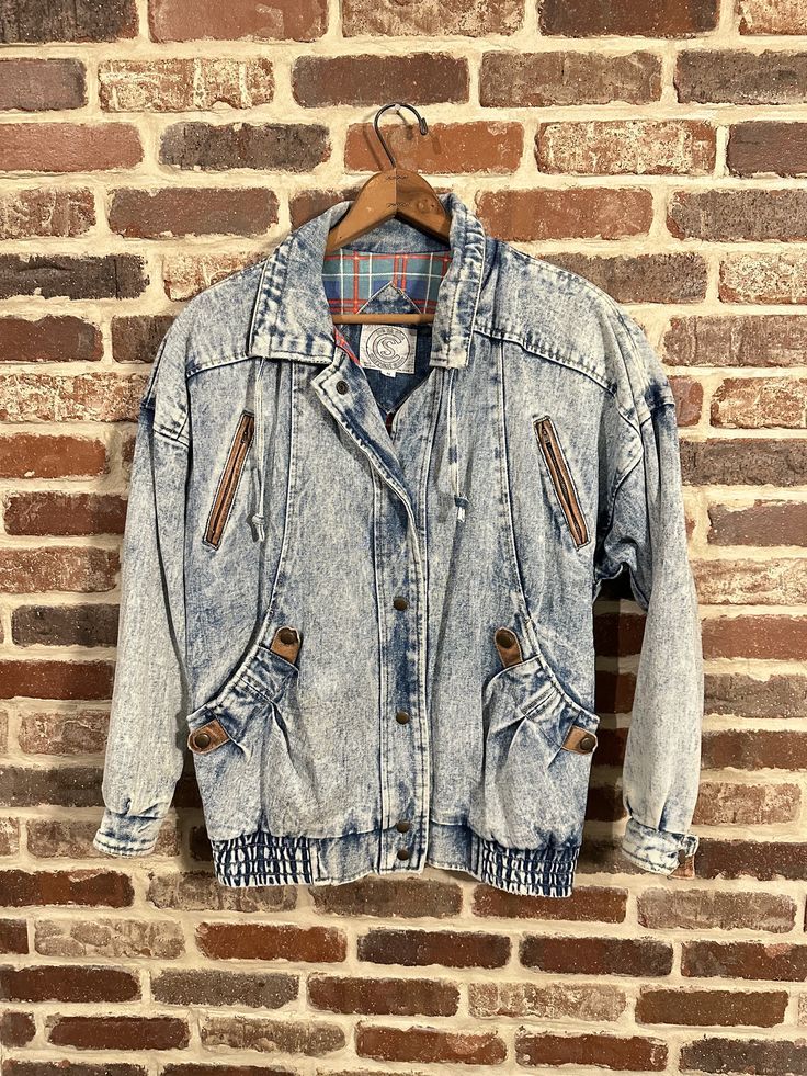 "Really cool acid washed women's denim jacket for sale by be in the Current Scene. This jacket is in great vintage condition. It has a flannel lining, nylon insulated sleeves, padded shoulders, snap cuffs, side hand warmer pockets, slanted zipper breast pockets, elastic waistband, leather hanging loop on the back, with sweet leather detailed snaps on the cuffs and side pocket, and a draw string leather detailed collar. In other words, this jacket has got it all! Act now, you don't want to miss o Vintage Denim Outerwear For Winter, Vintage Winter Denim Outerwear, 90s Style Denim Blue Winter Outerwear, Winter Acid Wash Distressed Outerwear, Acid Wash Denim Grunge Outerwear, Acid Wash Winter Outerwear With Pockets, Vintage Acid Wash Outerwear For Fall, Acid Wash Outerwear With Pockets For Winter, Winter Acid Wash Outerwear With Pockets