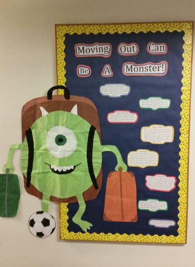 a bulletin board with an image of a monster and a soccer ball hanging on the wall