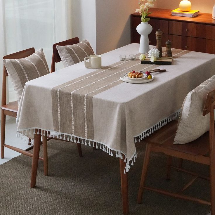 a dining room table with a plate of food on it and candles in the background