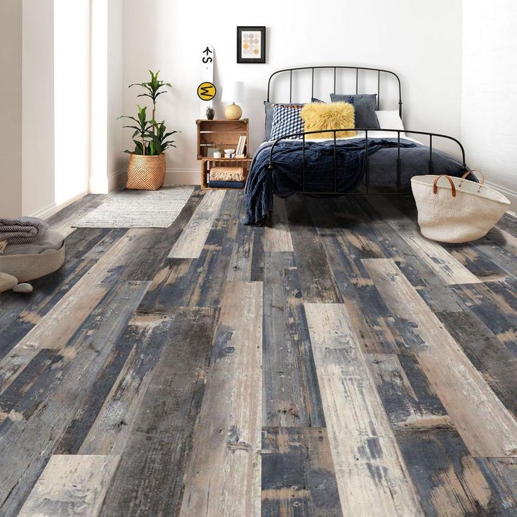 a bedroom with wood flooring and white walls