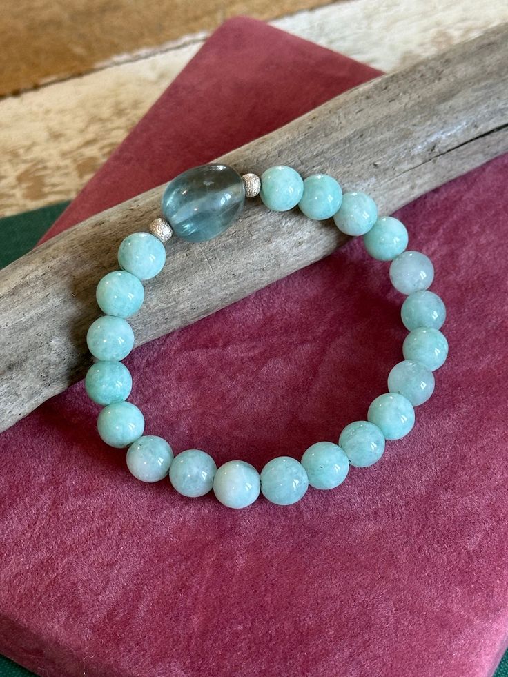 This is a stunning beaded gemstone bracelet. It is made using lovely aquamarine beads and a teal fluorite centre stone.  It also has sterling silver beads. This bracelet is approximately 19cm in length.  This would look great in a stack. If you love this and feel the price is a little out of reach, please pop me a message and we can sort something out. Aquamarine Beaded Bracelets As Gift, Beaded Aquamarine Bracelet For Gift, Turquoise Aquamarine Beaded Bracelets As Gift, Aquamarine Beaded Bracelet As Gift, Aquamarine Gemstone Beaded Bracelets For Healing, Healing Aquamarine Gemstone Beaded Bracelets, Healing Aquamarine Beaded Bracelets With Natural Stones, Healing Aquamarine Natural Stone Beaded Bracelets, Turquoise Aquamarine Beaded Bracelets With Natural Stones