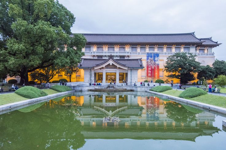 a building with a pond in front of it