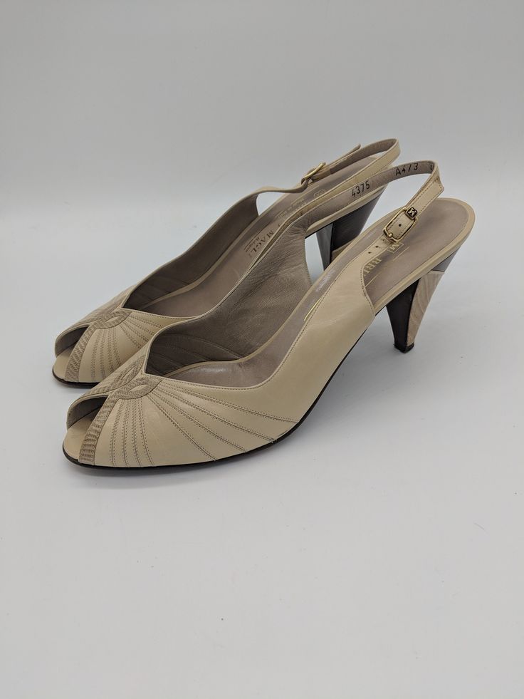 "Vintage 80's beige and brown leather peep-toe slingback heels by Bruno Magli. All real leather, made in Italy. Excellent condition, slight wear to the bottom of the sole but no other flaws found. Marked a size 8.5, but runs small. Best fits a size 7.5/8. Please check measurements. Length: 9.85\" Width: 3\" Heel height: 3.25\"" Retro Beige High Heels, Retro Beige Leather Heels, Retro Open Toe Slingback Pumps, Cream Leather Open Toe Slingback Pumps, Vintage Formal Sandals With 4-inch Heel, Vintage Beige Heels With Heel Strap, Beige Open Toe Leather Slingback Pumps, Vintage Slingback Heels For Spring, Beige Leather Open Toe Slingback Pumps