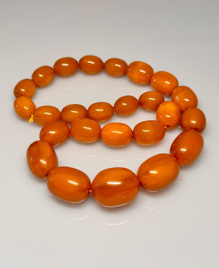 86 Grams Antique Bakelite Necklace Beads Marbled.           Very quality necklace with olive shape. All beads have rich veins. 25 total beads Biggest bead sizes 25.50 x 21 mm.  Smallest bead sizes 17 x 13.40 mm. For any questions feel free to as Classic Amber Necklaces For Jewelry Making, Amber Oval Beads Single Strand Necklace, Amber Single Strand Necklace With Oval Beads, Amber Necklace With Faceted Oval Beads, Amber Beaded Necklaces With Large Oval Beads, Amber Beaded Necklace With Large Oval Beads, Amber Necklaces With Polished Oval Beads, Amber Oval Beaded Necklaces For Jewelry Making, Amber Oval Beads Necklace For Jewelry Making