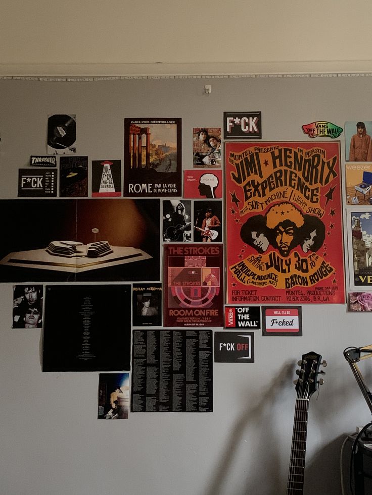 a wall covered with posters and guitars