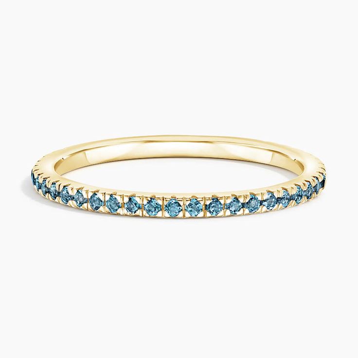 Luxe Ballad London Blue Topaz Wedding Ring - 18K Yellow Gold. This petite ring features scalloped pavé London Blue topaz in elegantly sculpted prongs that extend three-fourths of the way around the band, leaving a small sizing bar in back. Blue Topaz Ring Gold, Blue Wedding Band, Topaz Wedding Ring, Sky Blue Topaz Ring, Eternity Ring Gold, Petite Ring, London Blue Topaz Ring, Detailed Ring, Sky Blue Topaz