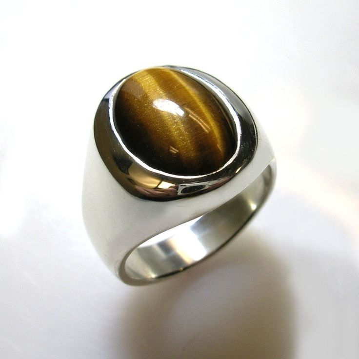 Masculine elegance. A truly stunning ring. Our own unique spin on a smart looking, timeless classic. We use finest quality, rare, Tiger Eye in a specially cut high dome that shows more stone which creates a unique and striking effect. This ring is solid- not hollowed out underneath which gives it a substantial value and weight and nicer feel and weighs from approx. 24 to 30 grams depending on the ring size. Truly looks great on a a wide range of finger sizes. (pictured on a size 10 ring finger) Luxury Oval Cabochon Gemstones, Domed Signet Ring With Polished Finish For Gift, Domed Signet Ring With Polished Finish For Anniversary, Timeless Domed Signet Ring With Polished Finish, Luxury Signet Ring With Oval Cabochon Gemstone, Luxury Oval Cabochon Gemstone Signet Ring, Timeless Oval Gemstone Signet Ring, Luxury Oval Cabochon Gemstones For Anniversary, Fine Jewelry Oval Cabochon Signet Ring For Formal Wear