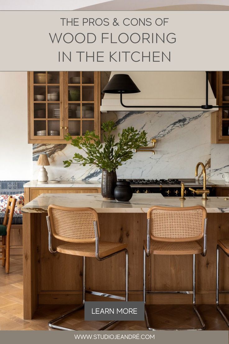 a kitchen with wooden cabinets and chairs around the counter top, along with an island