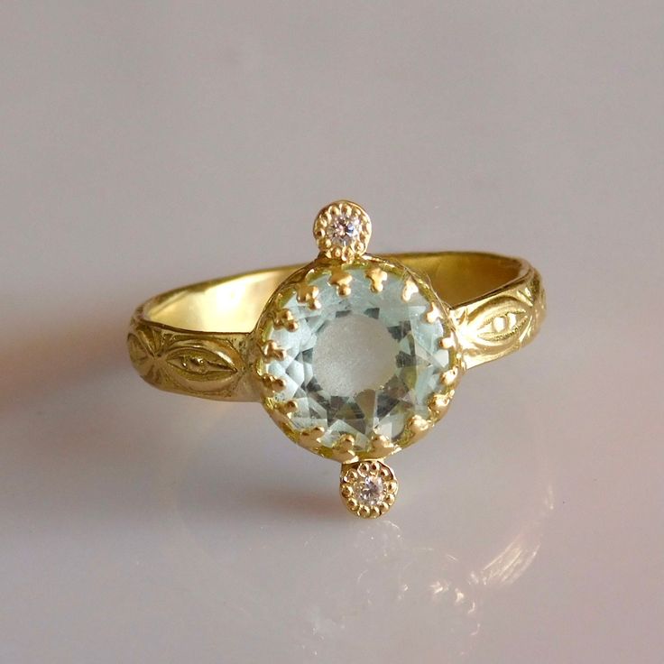 Fine beautifully detailed 18k Solid Gold AAA Aquamarine Solitaire Ring with Diamonds. 18k Solid Gold 2 x VS SI 0.01ct Natural Brilliant Ethically sourced Diamonds Free Sizing included from 4us to 7.5us Free worldwide Shipping Custom orders Welcomed! Aquamarine;  Aquamarine is a stone of breath, Confidence, clarity and Love. For more rings: https://www.etsy.com/shop/templejewelsibiza/items?section_id=21449468 To my shop: https://www.etsy.com/shop/templejewelsibiza Rings With Rose Cut Diamonds And Blue Topaz, Yellow Gold Rings With Blue Topaz And Diamond Accents, Yellow Gold Rings With Diamond Accents And Blue Topaz, 14k Gold Topaz Ring With Rose Cut Diamonds, Blue Topaz Rings With Rose Cut Diamonds, Elegant Aquamarine Ring With Ethical Diamonds, Yellow Gold Aquamarine Rings For Anniversary, Gold Diamond Ring With Blue Topaz In Round Cut, Yellow Gold Blue Topaz Diamond Ring