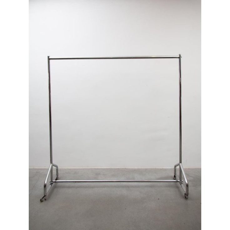 a metal rack with two bars on each side and an empty wall in the background