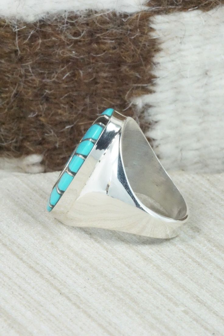 This turquoise and sterling silver inlay ring was made by Zuni silversmith Amy Wesley. The inside is signed Amy.Size: 10Length: 1 1/8"Width: 5/8"Free shipping on all orders! We ship with USPS and always include tracking. All orders ship within a day of payment.Returns are accepted up to 30 days after you receive your order. Just send us a message. Our shop offers cash back or store credit. The item must be returned in the same condition. Turquoise Rings With Polished Finish, Artisan Turquoise Ring In Sterling Silver With Polished Finish, Sterling Silver Turquoise Ring With Polished Finish For Anniversary, Turquoise Sterling Silver Rings With Polished Finish, Oval Engraved Turquoise Ring In Sterling Silver, Engraved Oval Turquoise Ring In Sterling Silver, Oval Turquoise Engraved Ring In Sterling Silver, Oval Turquoise Rings With Inlay, Oval Turquoise Inlay Rings