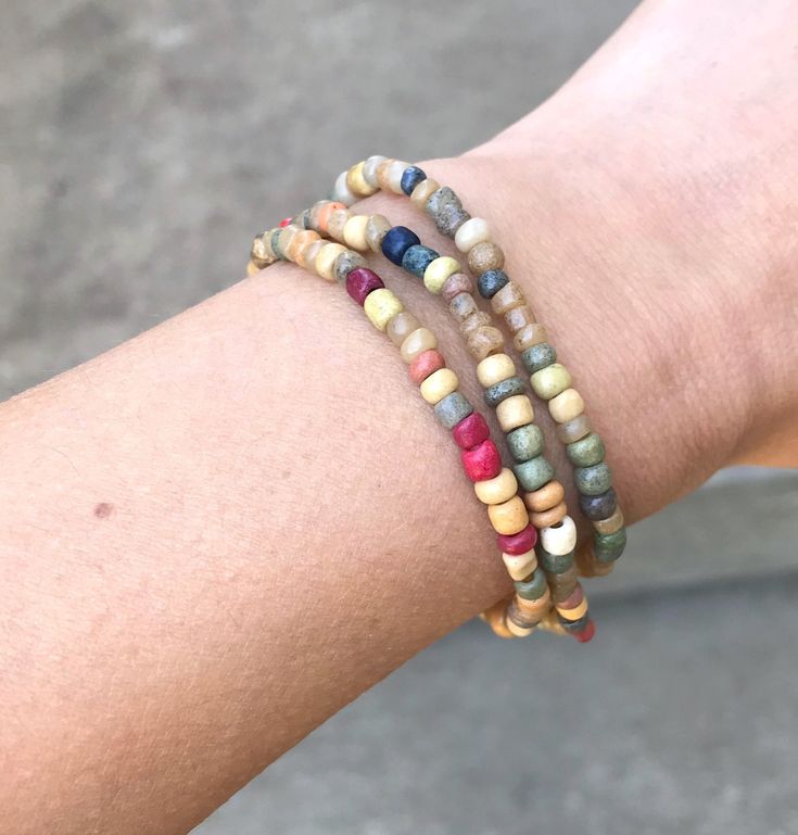 A simple set of three beaded bracelets. These have a random mix of seed beads in an earthy color palette. Easy to match with other pieces, and great for layering. Beaded on elastic cords, and comes packaged in a little gift box. This item will ship in 1 business day. Thank you for visiting my shop! If you would like to browse for more handmade items, here is the link to my home page: https://www.etsy.com/shop/ArtesanaAmericana Beaded Diy, Earth Tone Color, Earthy Color Palette, Beaded Bracelets Diy, Mixed Colors, Earthy Colors, Colorful Bracelets, Diy Bracelets, Earth Tones