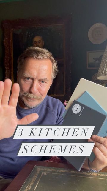 a man is holding up three kitchen schems in front of his face and the words 3 kitchen schems on it