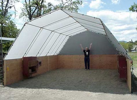 a person standing in front of a large structure with their hands up and arms raised