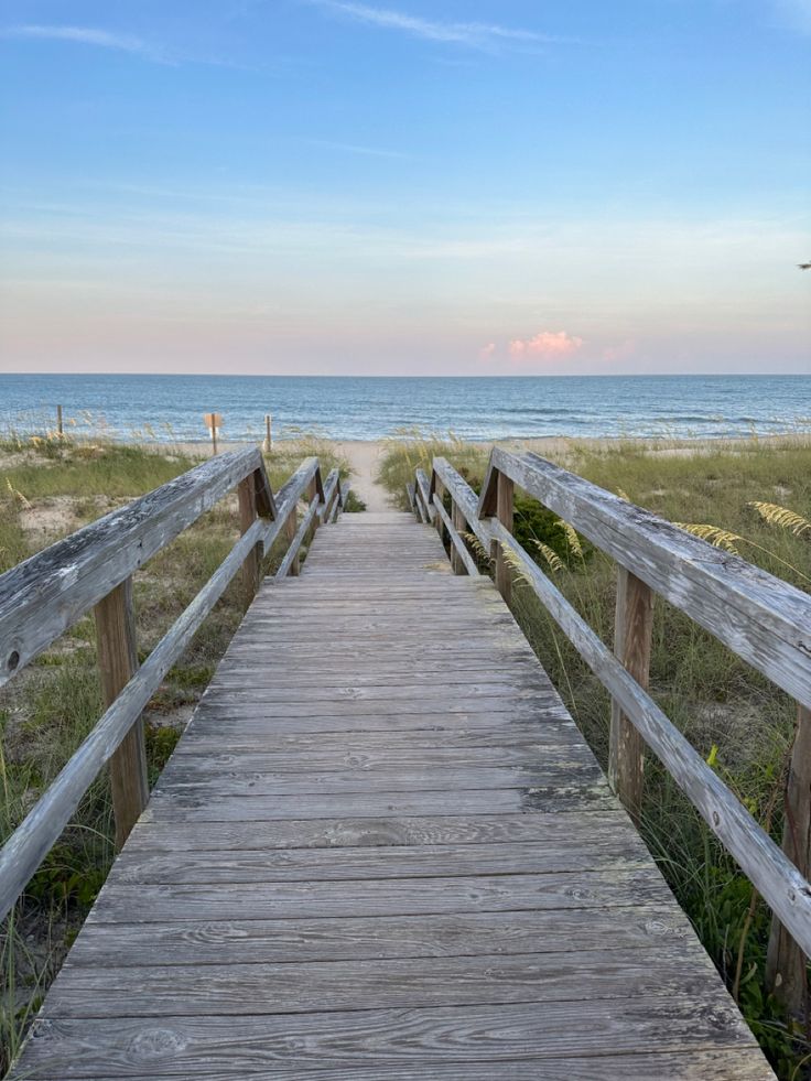 a wooden walkway leading to the beach