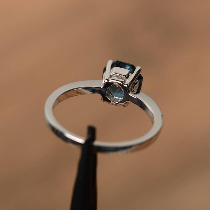 It is a real London blue topaz ring, octagon cut, measures 7mm*7mm, weight about 1.86 cts. The basic metal is sterling silver and plated with rhodium. To change the metal to a solid gold (white/rose) or platinum is also available, please ask for a quotation if you want. You can also go to my shop Home for more elegant rings: https://www.etsy.com/shop/godjewelry?ref=hdr_shop_menu London blue topaz is birthstone of November More London blue topaz rings: https://www.etsy.com/shop/godjewelry?ref=sel Radiant Cut Birthstone Ring In White Gold, White Gold Radiant Cut Birthstone Ring, Silver Radiant Cut Birthstone Rings, Silver Birthstone Ring With Radiant Cut, Blue Topaz Emerald Cut Ring With Bezel Setting, Anniversary Topaz Ring With Prong Setting In Octagon Shape, Octagon Birthstone Ring For Promise, Silver Octagon Topaz Promise Ring, Octagon Sapphire Ring With Prong Setting For Anniversary