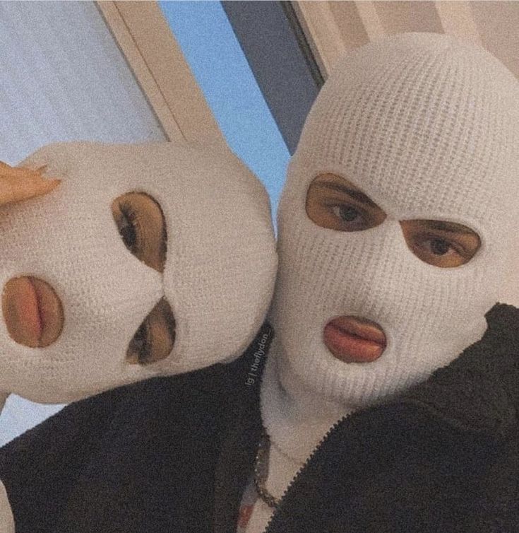 two people with white masks on their faces