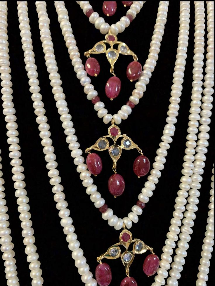 Made upon order bridal set fresh water pearls used Rubies used ( Chatham) Ruby beads in hanging 22ct gold plated includes - choker , earrings , jhoomar tika and satlada ships in 3-4 weeks from Levittown Pennsylvania Elegant Ruby Bridal Necklace With Stone Work, Traditional White Ruby Bridal Necklace, Elegant Kundan Necklace With Ruby For Reception, Traditional Jewelry Sets With Pearl Drop For Reception, Traditional Pearl Bridal Necklace For Reception, Traditional Pearl Embellished Jewelry For Festivals, Traditional Pearl Drop Jewelry Sets For Reception, White Ruby Necklaces For Wedding, Traditional Pearl-embellished Jewelry For Festivals