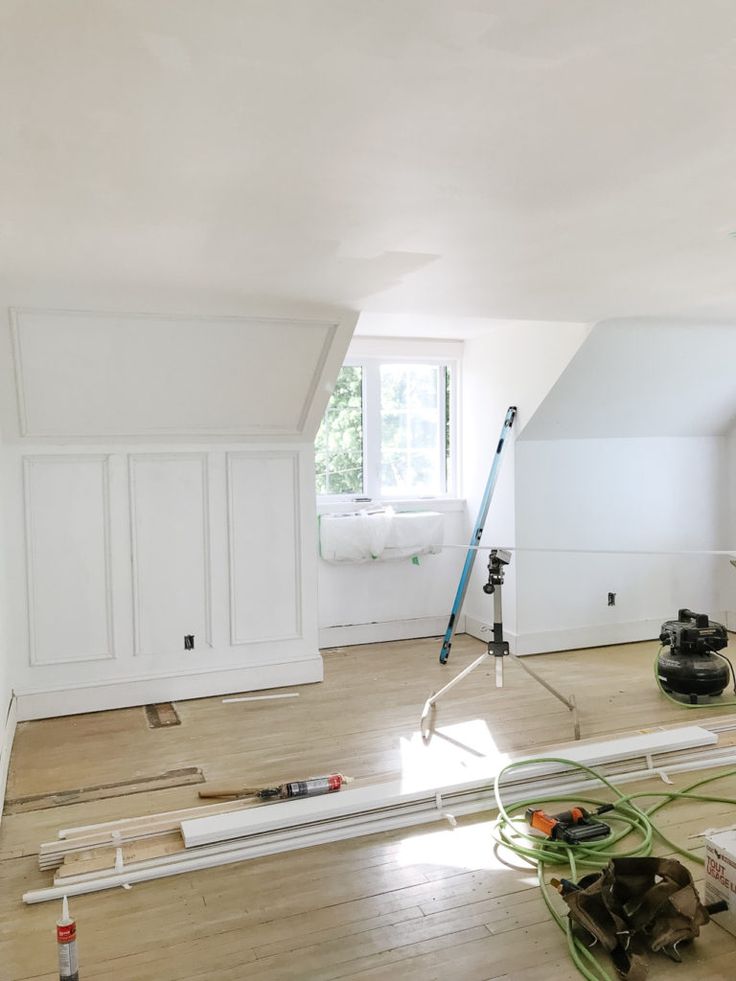 an empty room with tools and equipment on the floor