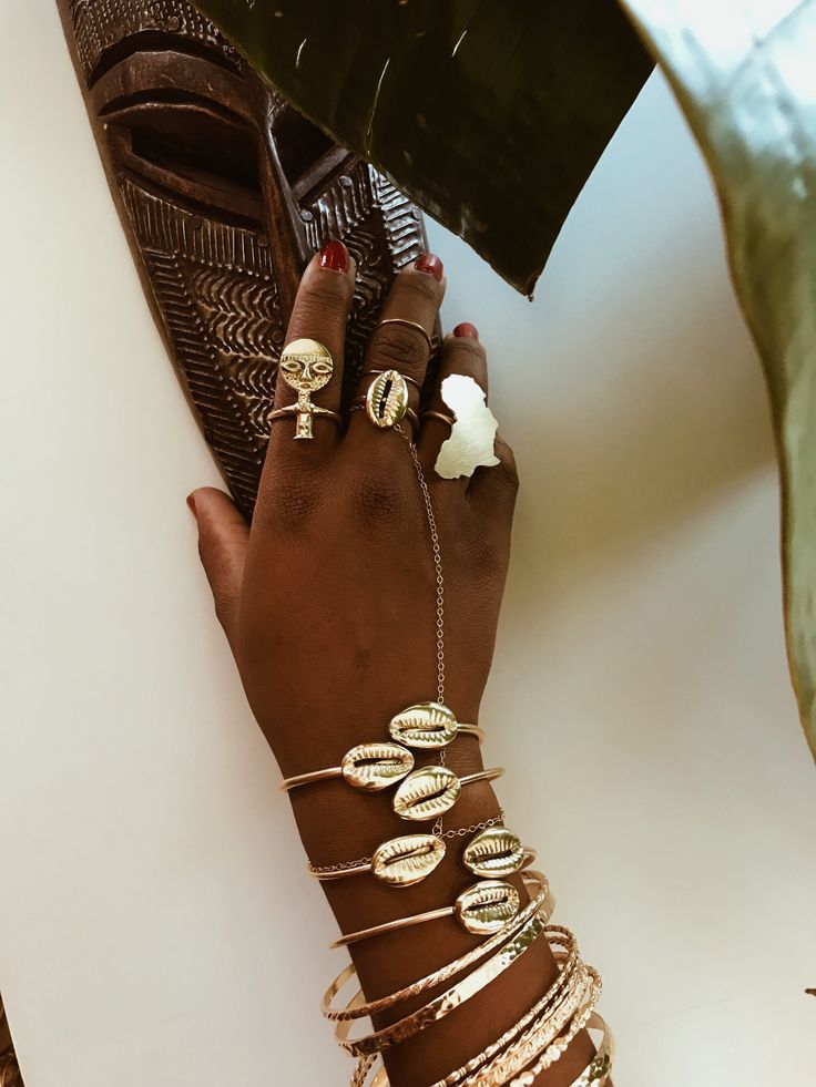 Beautiful brass cowrie shells on a brass adjustable cuff. The cowrie shell represents Goddess protection, as well as symbolizes the power of destiny and prosperity. It is perfect worn alone or with a few of our stack rings Details: 0.75” Cowrie ShellS Adjustable Brass Cuff Packaged for gift giving. *Sold as a single cuff. Not a set. Cowrie Shell Jewelry Necklaces, Afro Jewelry, African Beaded Bracelets, Cowrie Shell Jewelry, Afrocentric Jewelry, Dope Jewelry Accessories, Stack Rings, Earthy Jewelry, Cowrie Shells