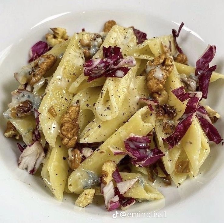 a white bowl filled with pasta and vegetables