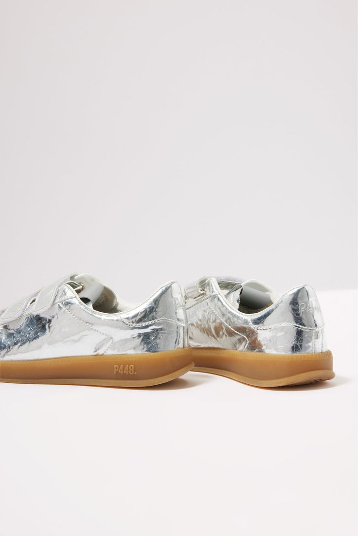 Add some shine to your look with these silver metallic sneakers by P448, featuring a low-top silhouette with a velcro closure, amber tread, and comfy memory foam insole. Each pair of P448 sneakers is crafted to maximize comfort, while the unexpected color combinations, textures, and patterns add a unique flair. All P448 sneakers are designed and made in Italy. | P448 Women's Monza Velcro Sneakers, Size 41, Silver Modern Metallic Sneakers With Rubber Sole, Modern Metallic Silver Sneakers With Round Toe, Modern Metallic Silver Round Toe Sneakers, Silver Sneakers With Removable Insole, Silver Sneakers With Removable Insole And Round Toe, P448 Sneakers, Unexpected Color Combinations, Textures And Patterns, Fall Closet