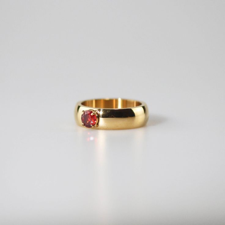 This Ruby Solitaire Ring boasts a minimalist design with a highly polished finish that mirrors light elegantly. The little round ruby gemstone which is set right in the middle of the band is just like the topping on a tempting cupcake. 18k gold plated Stainless steel base Waterproof and tarnish free Available in US 6-8 Ring sizing chart Minimalist Gold Solitaire Ruby Ring, Minimalist Gold Ruby Ring For Formal Occasions, Minimalist Gold Ruby Ring With Bezel Setting, Ruby Gold Ring, Ruby Solitaire Ring, Personalized Gift Cards, Ring Plate, Red Jewel, Ruby Gemstone