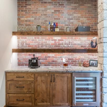 a kitchen with brick walls and wooden cabinets