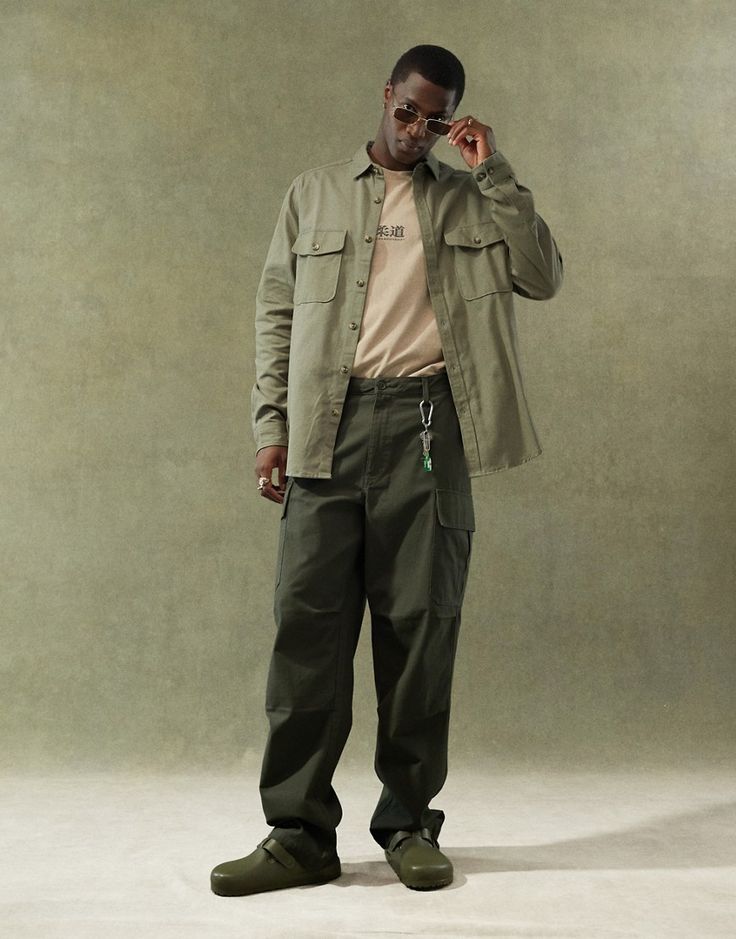 Suit pants by ASOS DESIGN May cause compliments Regular rise Belt loops Functional pockets Baggy fit Green Baggy Cargo Pants Outfit, Fall Streetwear Cargo Pants With Welt Pockets, Fall Cargo Pants With Welt Pockets For Streetwear, Military Style Relaxed Fit Cargo Pants With Flap Pockets, Green Cotton Pants With Flap Pockets, Urban Green Pants For Fall, Relaxed Fit Cargo Pants With Welt Pockets For Streetwear, Baggy Khaki Cargo Jeans For Workwear, Utility Cargo Pants With Welt Pockets For Outdoor