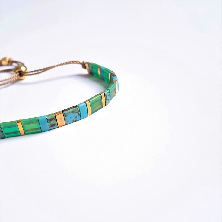 Beautiful colorful adjustable Bracelet, Miyuki Tila beads are hand strung on silk thread, the bracelet opens and closes easily with a gold plated sliding bead. Lovely on its own or combined with your other favorite braclets. Please note this listing is for one bracelet, also as a set available with skinny gemstone bracelet: https://www.etsy.com/listing/973378432/bracelet-set-with-a-tila-bracelet-and S I Z E : Bracelet opens up to 24 cm and nearly always fits, has to be shoven over your hand. If Tile Bracelet, Bracelet Miyuki, Tila Beads, Bracelet Summer, Small Letters, Silk Cord, Cord Bracelets, Silk Thread, Summer Jewelry