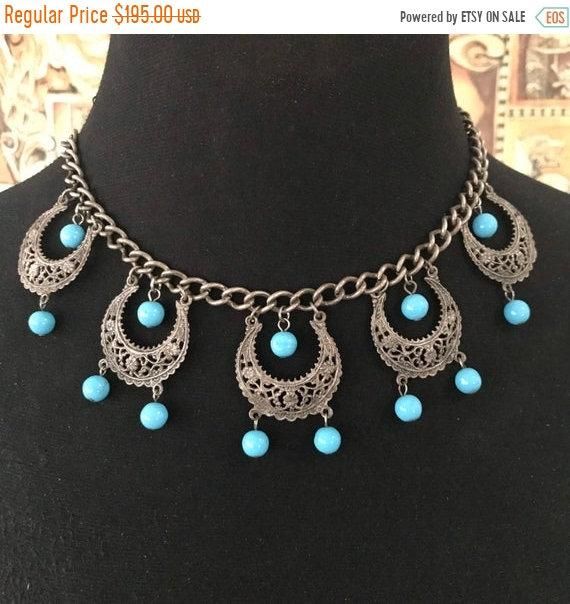 156.00 USD ❘❘❙❙❚❚ ON SALE ❚❚❙❙❘❘ Pretty blue beaded vintage 1960s necklace in good vintage condition. Measures 16 and three-quarter inches long by almost 2 inches dangling down. Would dress up any outfit and is a nice addition to any collection. Retro Blue Beaded Jewelry, Blue Beaded Retro Jewelry, Blue Vintage Necklace For Festival, Vintage Blue Necklace With Beaded Chain, Vintage Blue Turquoise Necklace, Vintage Blue Choker Jewelry, Vintage Blue Beaded Chain Necklace, Vintage Blue Choker Necklace, Luxury Vintage Blue Beaded Necklace