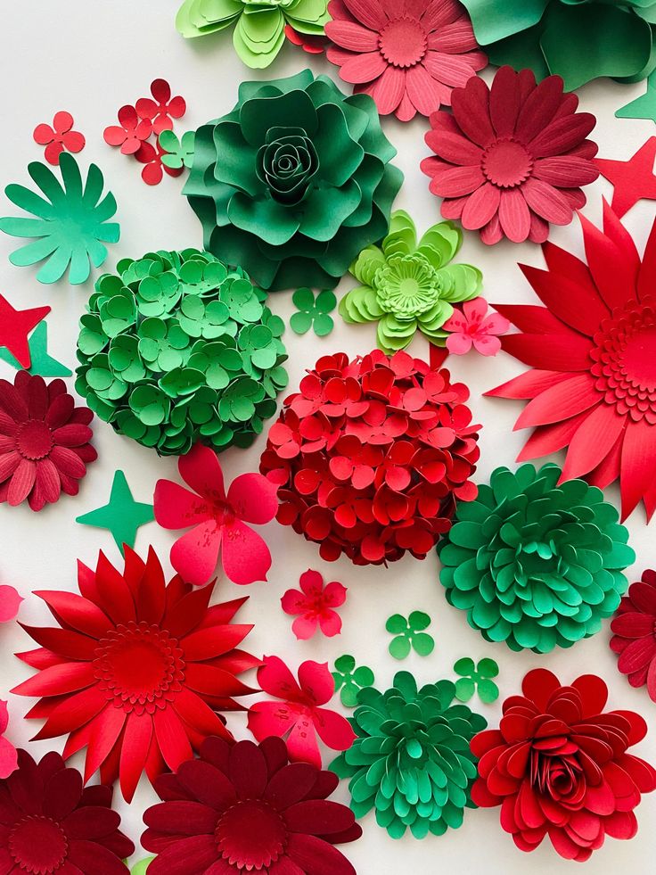 red and green paper flowers laid out on top of each other