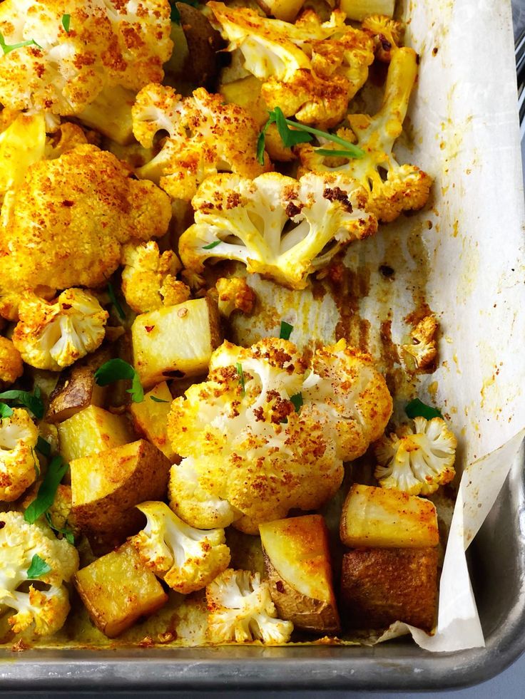 roasted cauliflower and potatoes in a baking pan