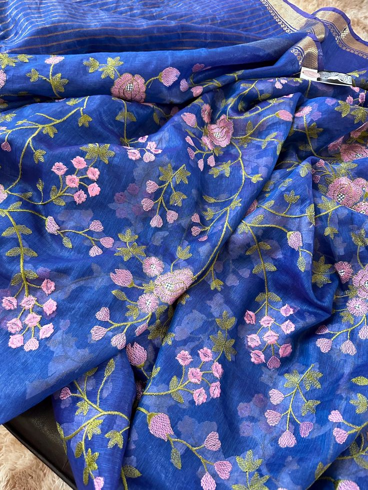 Tussar linen silk saree in unique blue and pink combination. The saree is heavily embroidered all over. Blue Bollywood Tussar Silk Saree, Blue Tussar Silk Dupatta With Zari Weaving, Blue Tussar Silk Dupatta With Pallu, Unstitched Blue Raw Silk Saree, Blue Chanderi Saree With Traditional Drape, Blue Tussar Silk Dupatta In Traditional Drape, Blue Bollywood Tussar Silk Dupatta, Blue Bollywood Style Tussar Silk Dupatta, Designer Blue Silk Saree