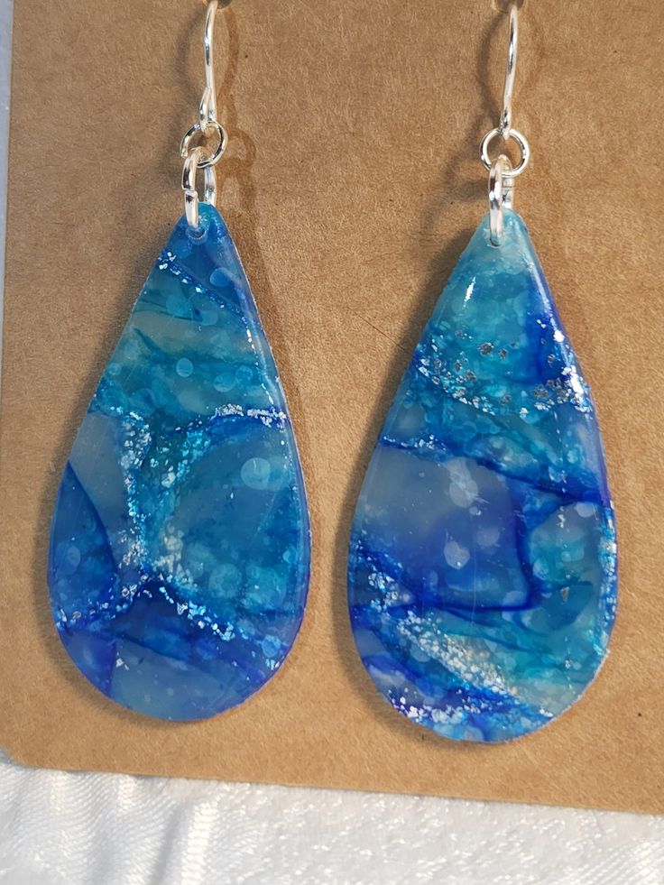 Large Blue Marbled teardrop dangle earrings. Made of polymer clay and resin with sterling silver hooks. Teardrop Clay Earrings, Handmade Resin Teardrop Earrings, Handmade Teardrop Resin Earrings, Teardrop Resin Jewelry, Blue Teardrop Resin Jewelry, Unique Teardrop Resin Earrings, Blue Teardrop Pendant Earrings As Gift, Resin Teardrop Earrings For Gifts, Blue Long Drop Teardrop Earrings