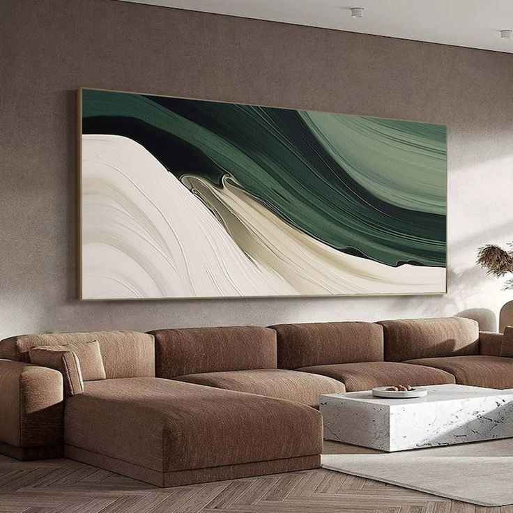 a living room with a large painting on the wall and couches in front of it