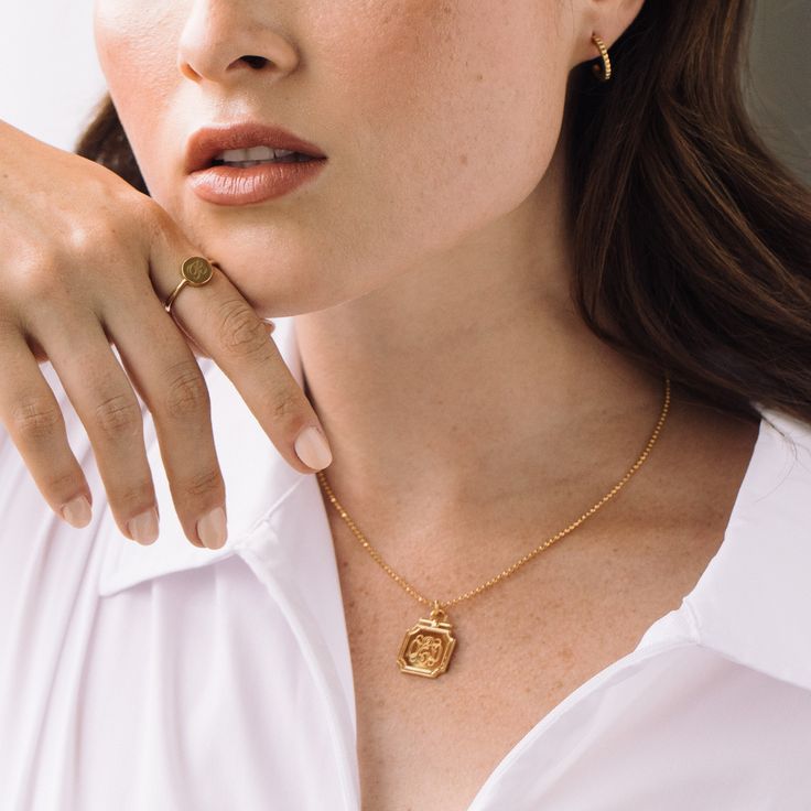 Introducing the Margot Pendant - a personalized statement piece that adds just the right sparkle to any outfit. Its unique diamond cut ball chain and on-trend pendant create a look that is both bold and stylish, making it the perfect accessory for any occasion. Available in 14k gold plated, rhodium plated or 14k rose gold plated brass Pendant size: 3/4" 16" diamond cut ball chain with 2" extender Lobster claw closure With engraving this item is FINAL SALE SKU: BYN1252 Recycled Gold Coin Pendant Jewelry Gift, Trendy Ball Chain Necklace For Gift, Trendy Ball Chain Necklace As Gift, Yellow Gold Ball Chain Jewelry Gift, Trendy Gold-plated Round Pendant Jewelry, Everyday Gold Plated Medallion Jewelry, Recycled Gold Box Chain Jewelry As A Gift, Recycled Gold Box Chain Jewelry Gift, Recycled Gold Box Chain Jewelry For Gift