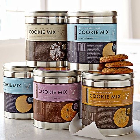 six tins of cookie mix sitting on top of a counter