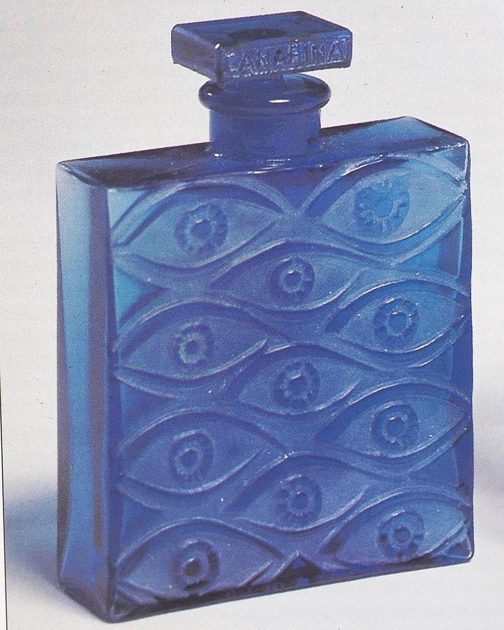 a blue glass flask with an ornate design