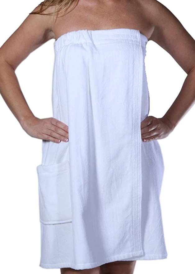 a woman in a white towel is standing with her hands on her hips