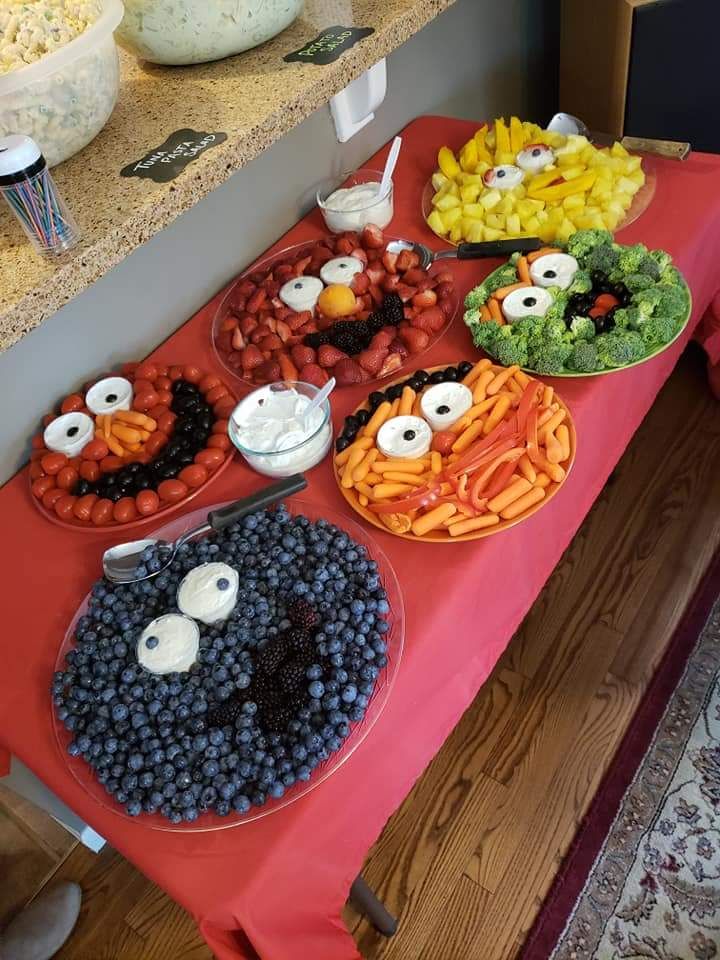 a table topped with lots of food on top of a red table cloth