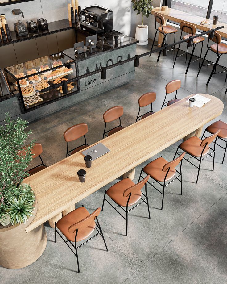 an overhead view of a table with chairs and a laptop on it in a restaurant