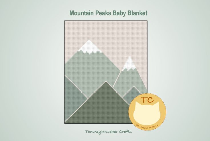 the mountain peaks baby blanket is shown with a gold medal